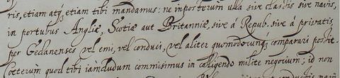 Black and white photograph. A close-up, cropped section showing a passage of handwritten text in elaborate cursive writing onto a white sheet of paper. Included are the words, ‘Anglia’, ‘Scotia’, and ‘Britannia’. 
